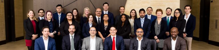 Houston EB5 investment group posing in a professional corporate setting, showcasing success and teamwork in U.S. immigration and EB-5 visa programs.