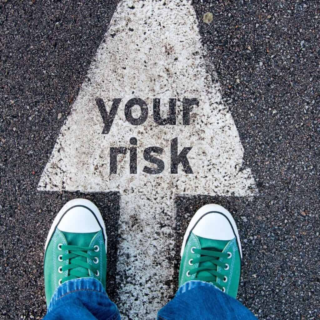 Risk of financial loss warning on street pavement emphasizing cautious investment in Houston EB5 programs.